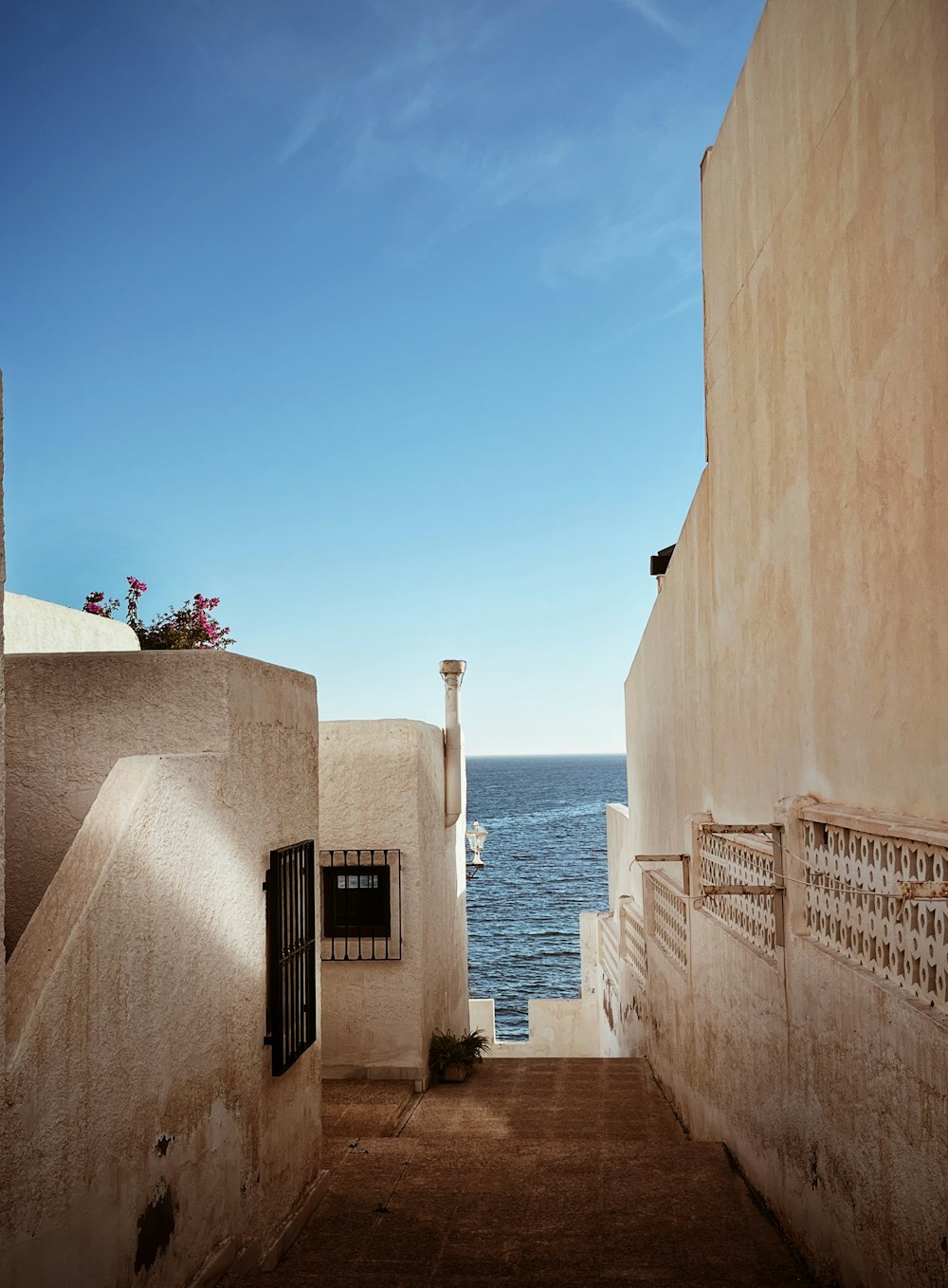 a view of the ocean from an alley way