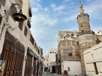 a narrow street with a tall building in the background