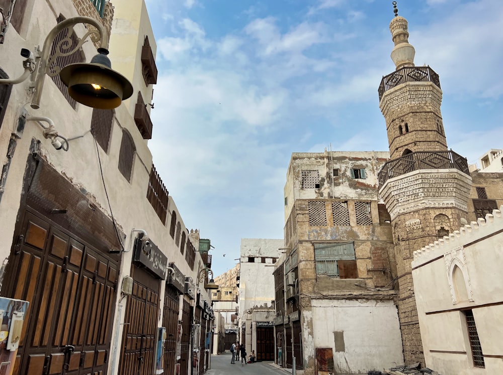 a narrow street with a tall building in the background