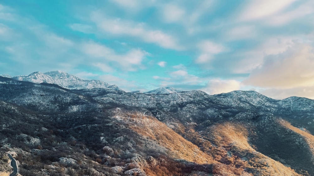 a view of a mountain range with snow on the mountains