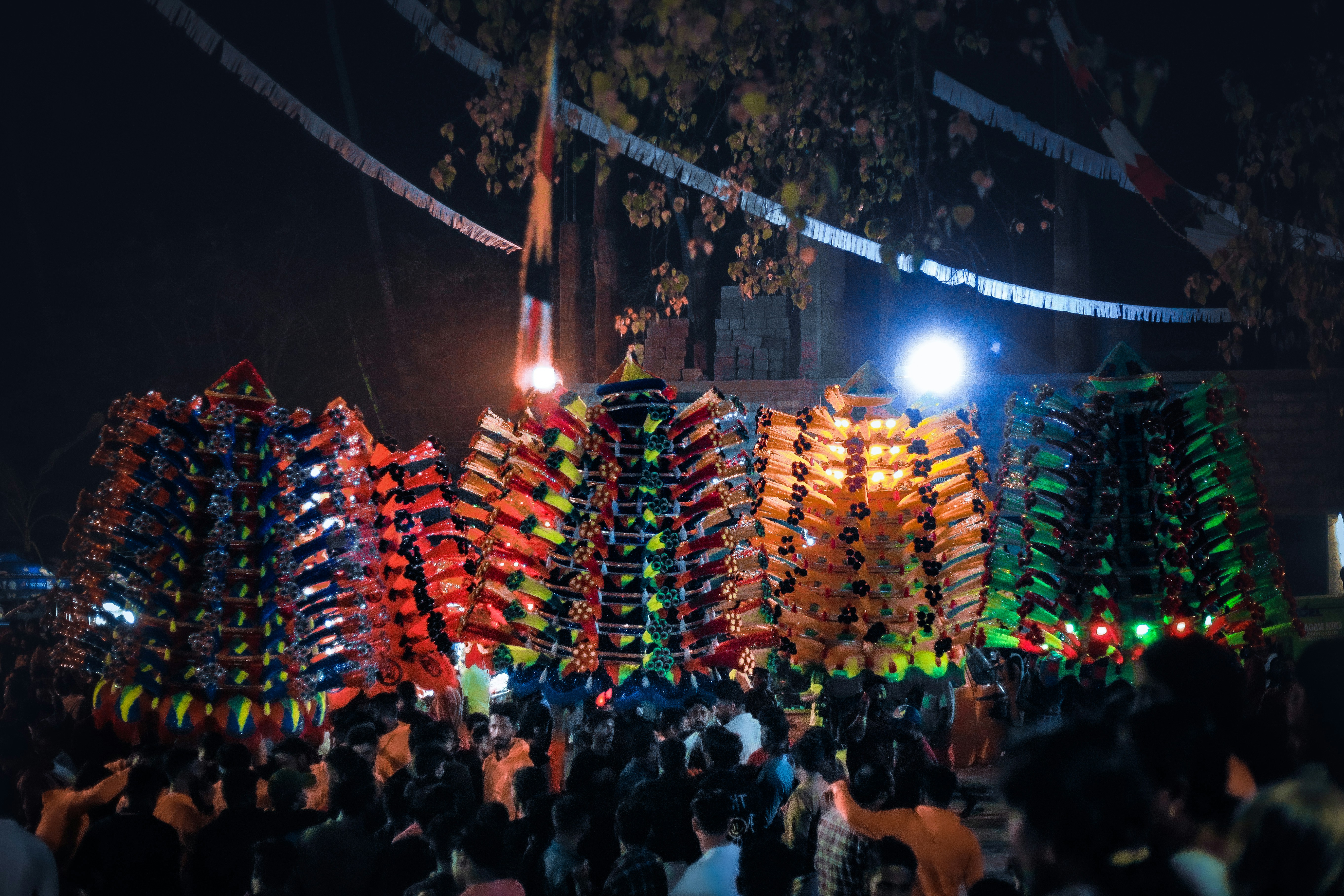 a crowd of people standing around a display of kites