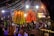 A vibrant event scene with people enjoying themselves and smiling, surrounded by colorful decorations.