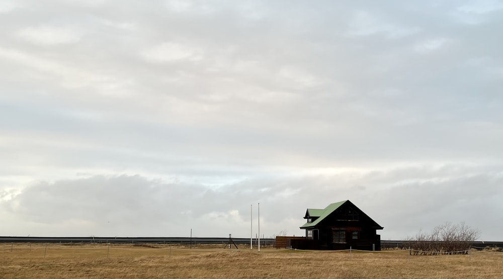 a house in a field with a green roof