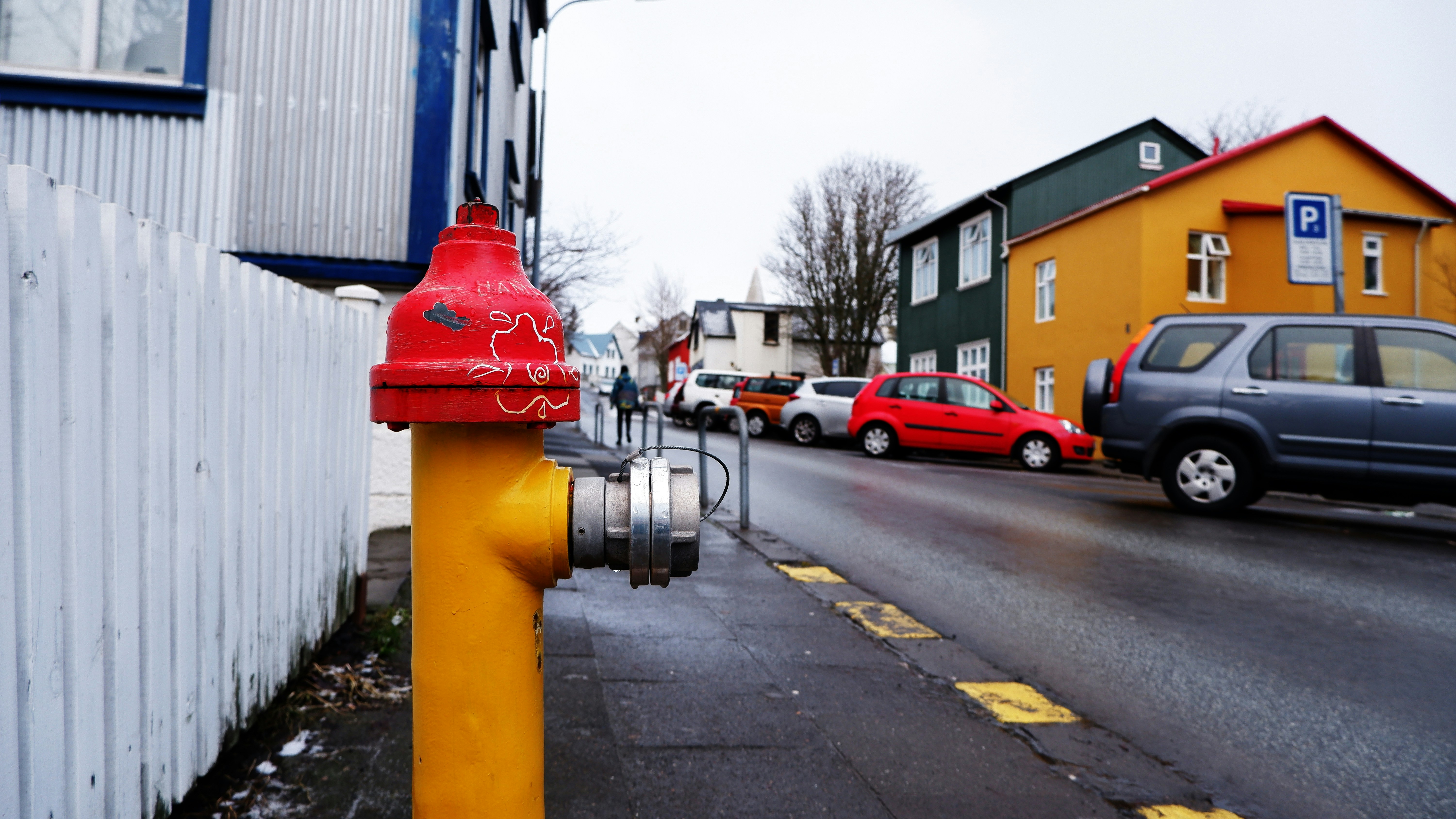 a red fire hydrant sitting on the side of a road