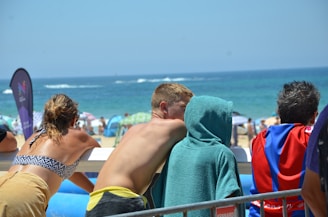 Group of happy tourists enjoying a sunny beach during a guided tour.