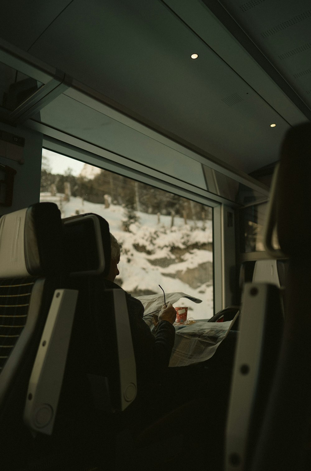 a man sitting in a train looking out the window