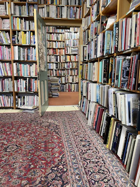 Cozy bookstore corner filled with Islamic books and warm lighting.
