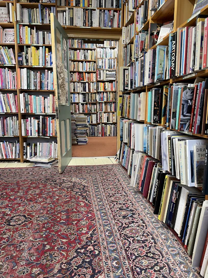 Cozy bookstore corner filled with Islamic books and warm lighting.