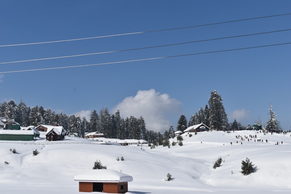a snow covered hill with houses and power lines