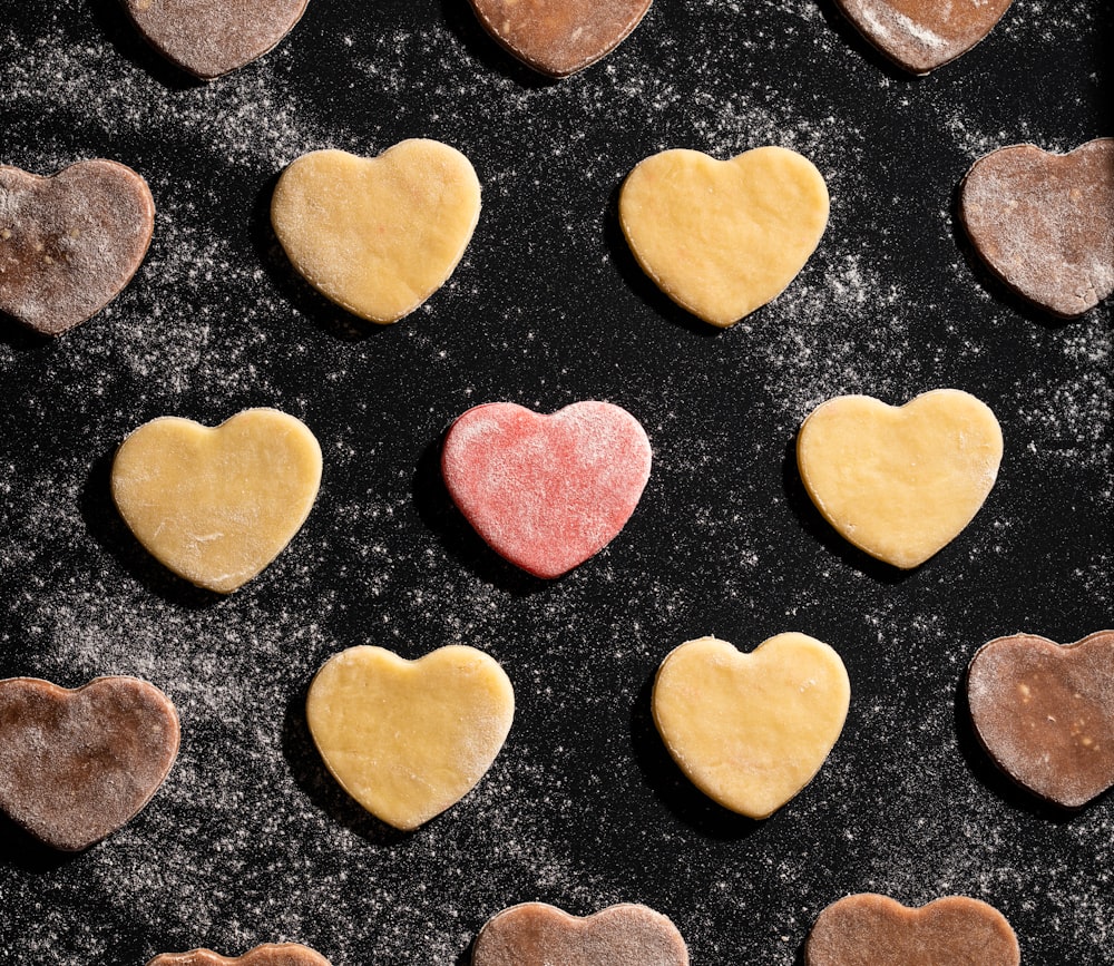 heart shaped cookies are arranged on a baking sheet