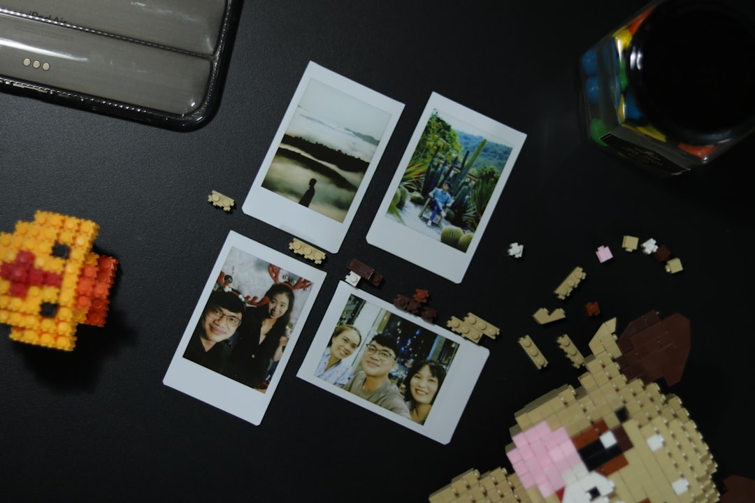 a black table topped with pictures of people and legos,