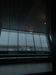 Interior view of a luxury aircraft hangar featuring polished concrete floors and custom lighting.