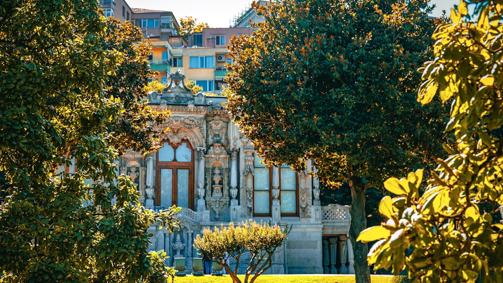 a building with many windows and trees in front of it