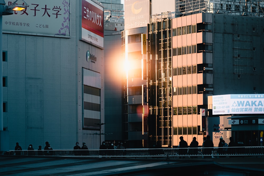 a group of people walking across a bridge over a river