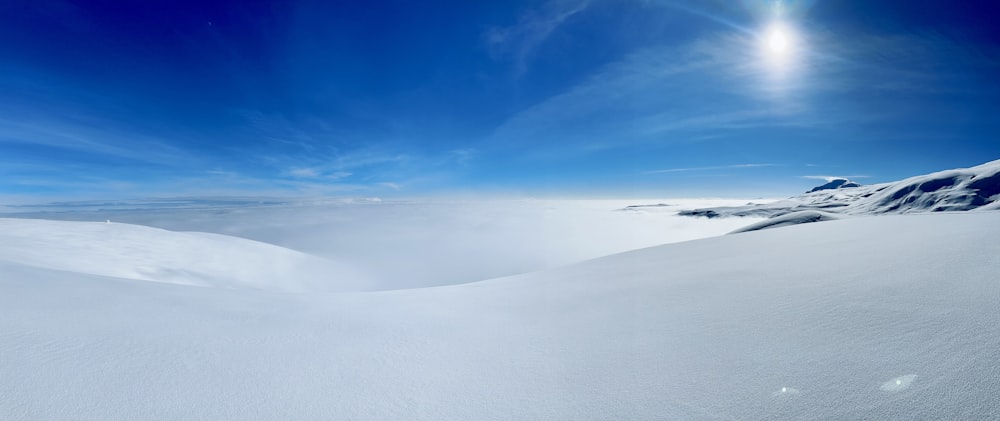 a snow covered mountain under a blue sky