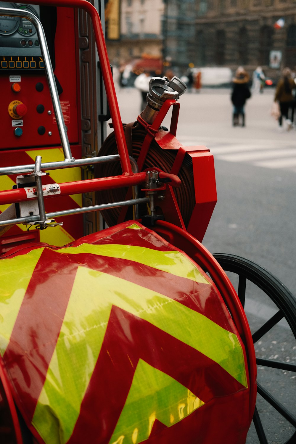 a red and yellow fire hydrant sitting on the side of a road