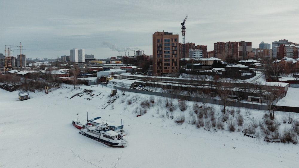 a snow covered field with a boat in the middle of it