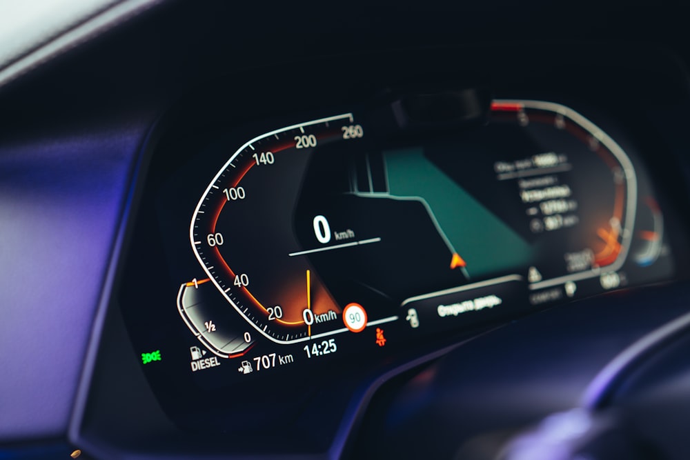 a car dashboard with a speedometer and a dash light