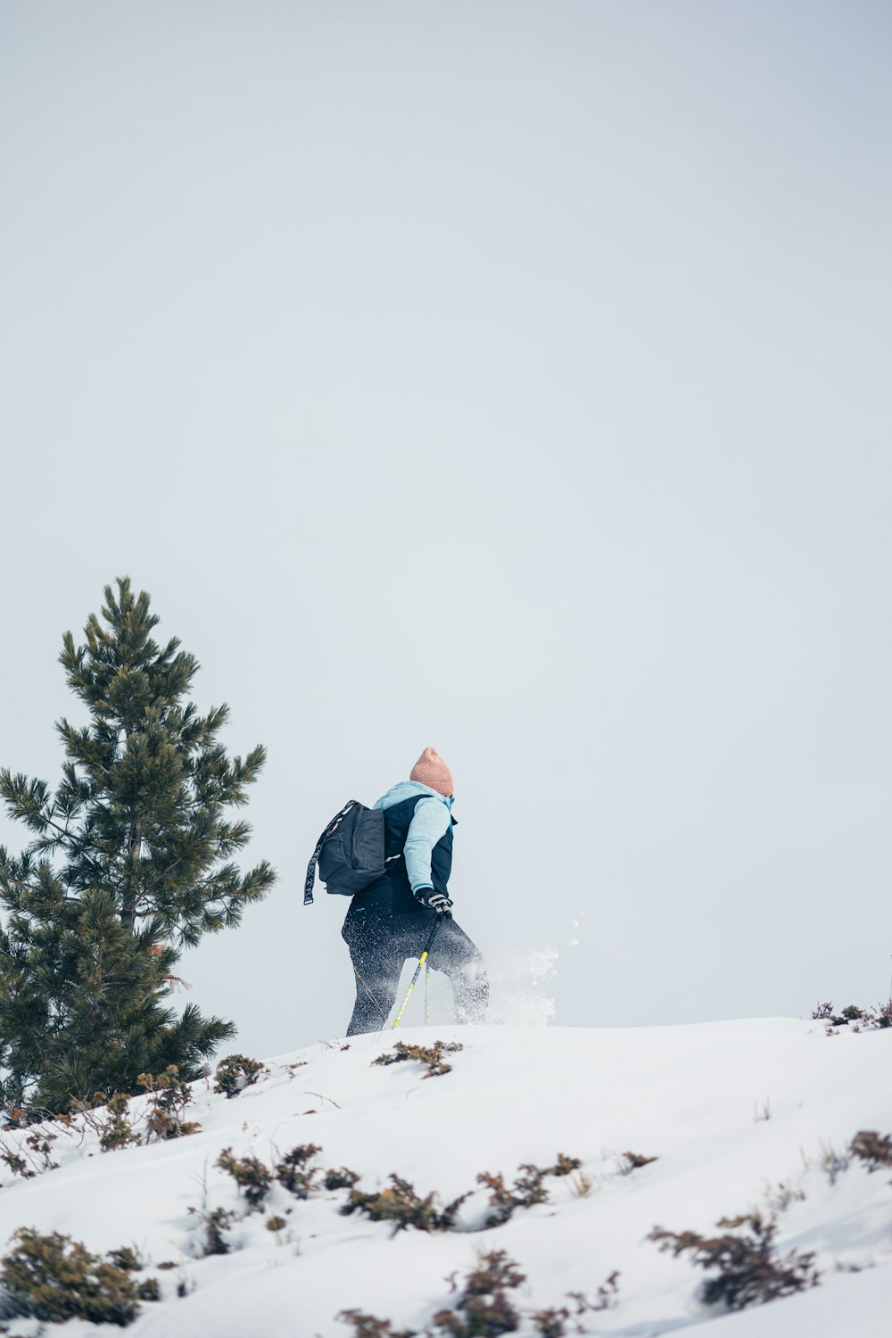 a man riding skis down a snow covered slope