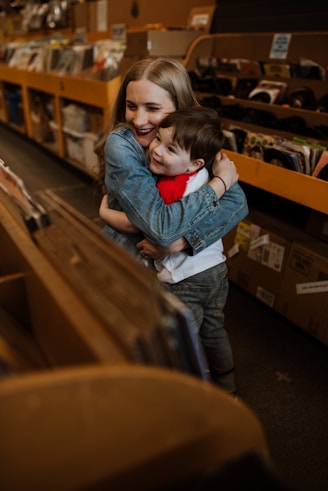A mother and daughter smiling and hugging, sharing a special moment with a digital song gift.