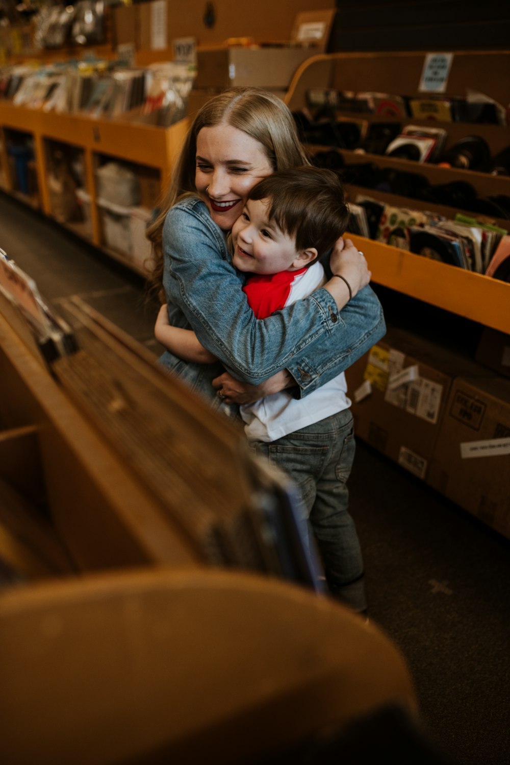 a woman hugging a child in a store