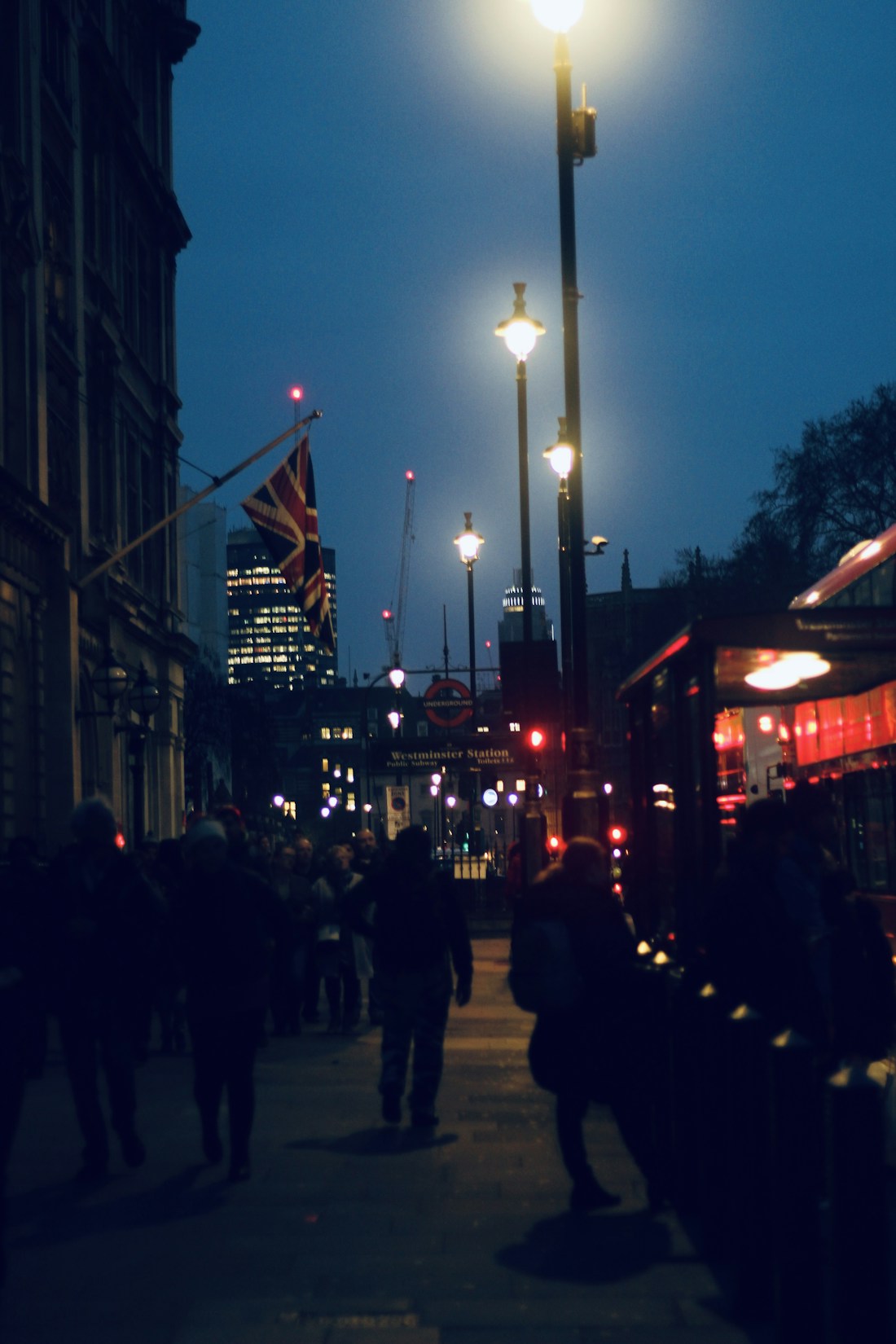 People walking down a busy city street at night, placeholder audience image