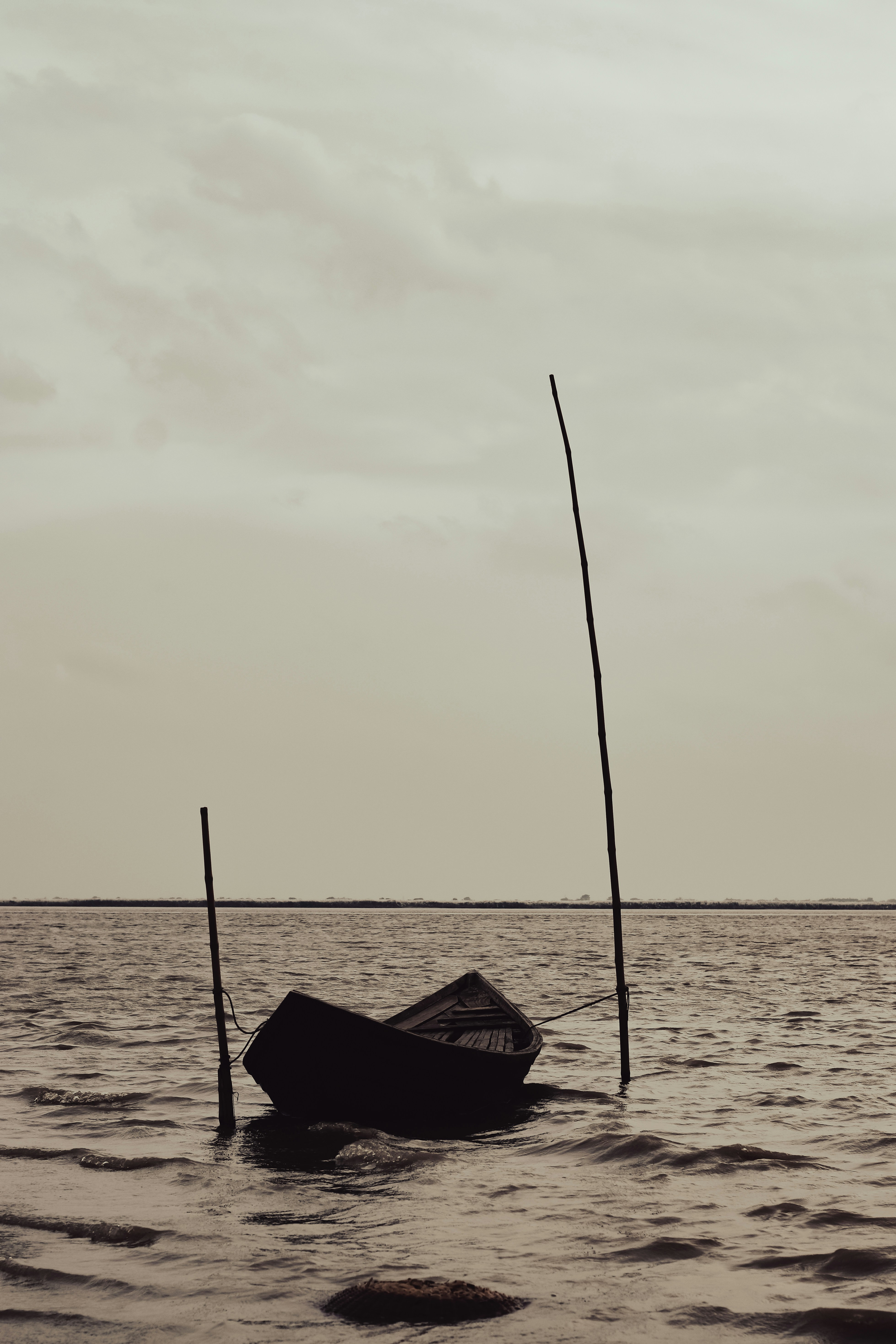 a small boat floating on top of a body of water