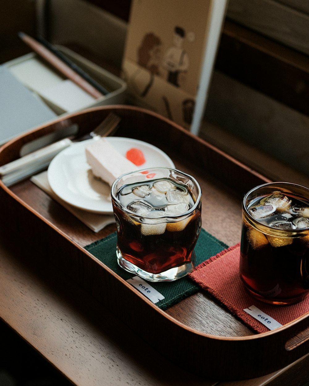 a tray with two glasses of drinks on it