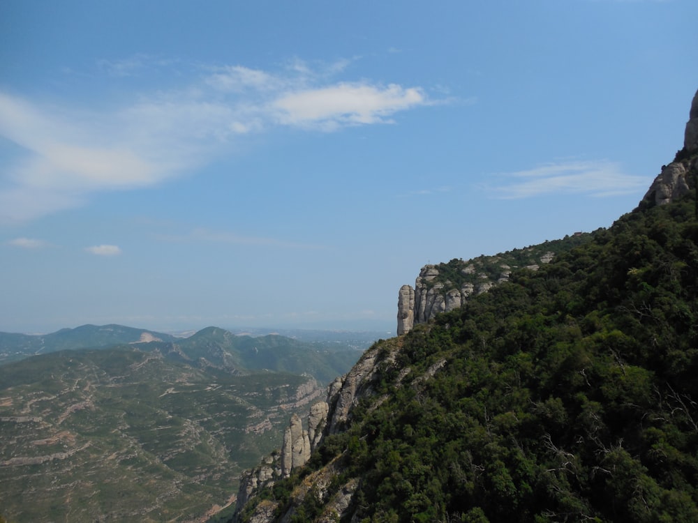 a view of the mountains from the top of a hill