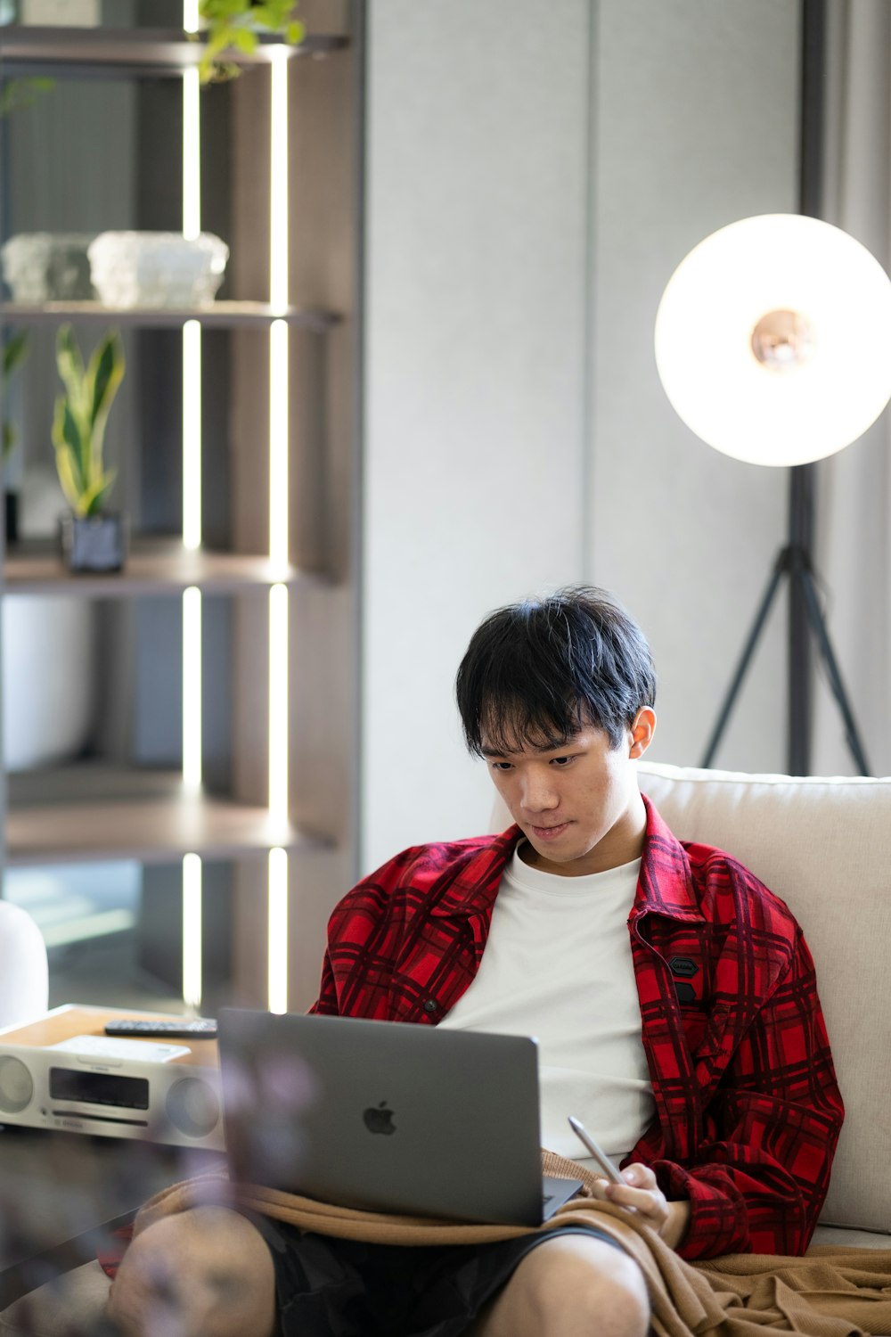 a man sitting on a couch using a laptop computer