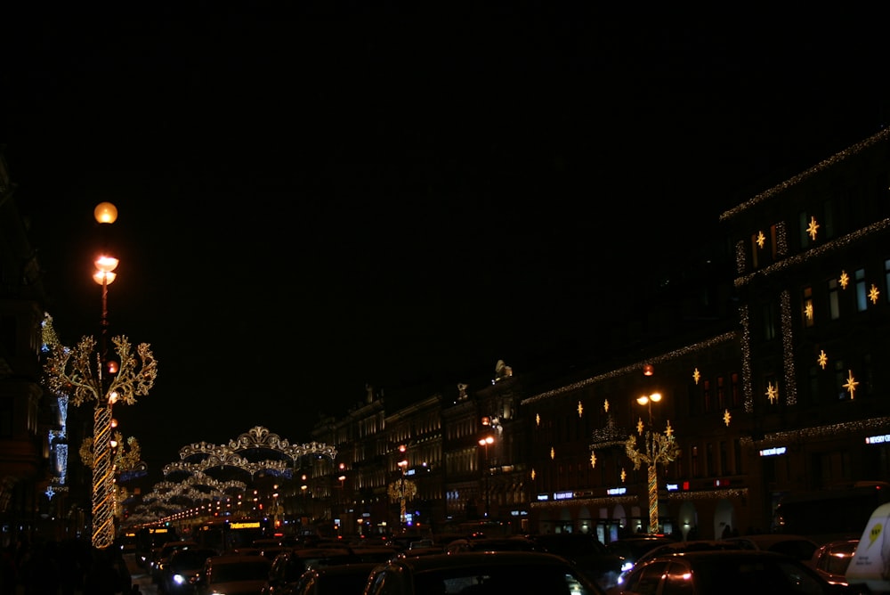 a city street filled with lots of traffic at night