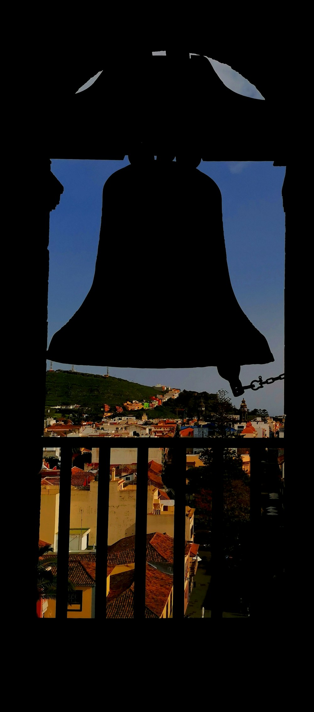 a large bell hanging from the side of a building