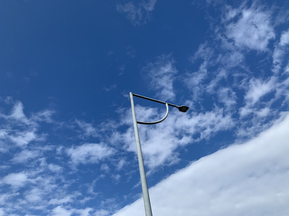 a street light with a blue sky in the background