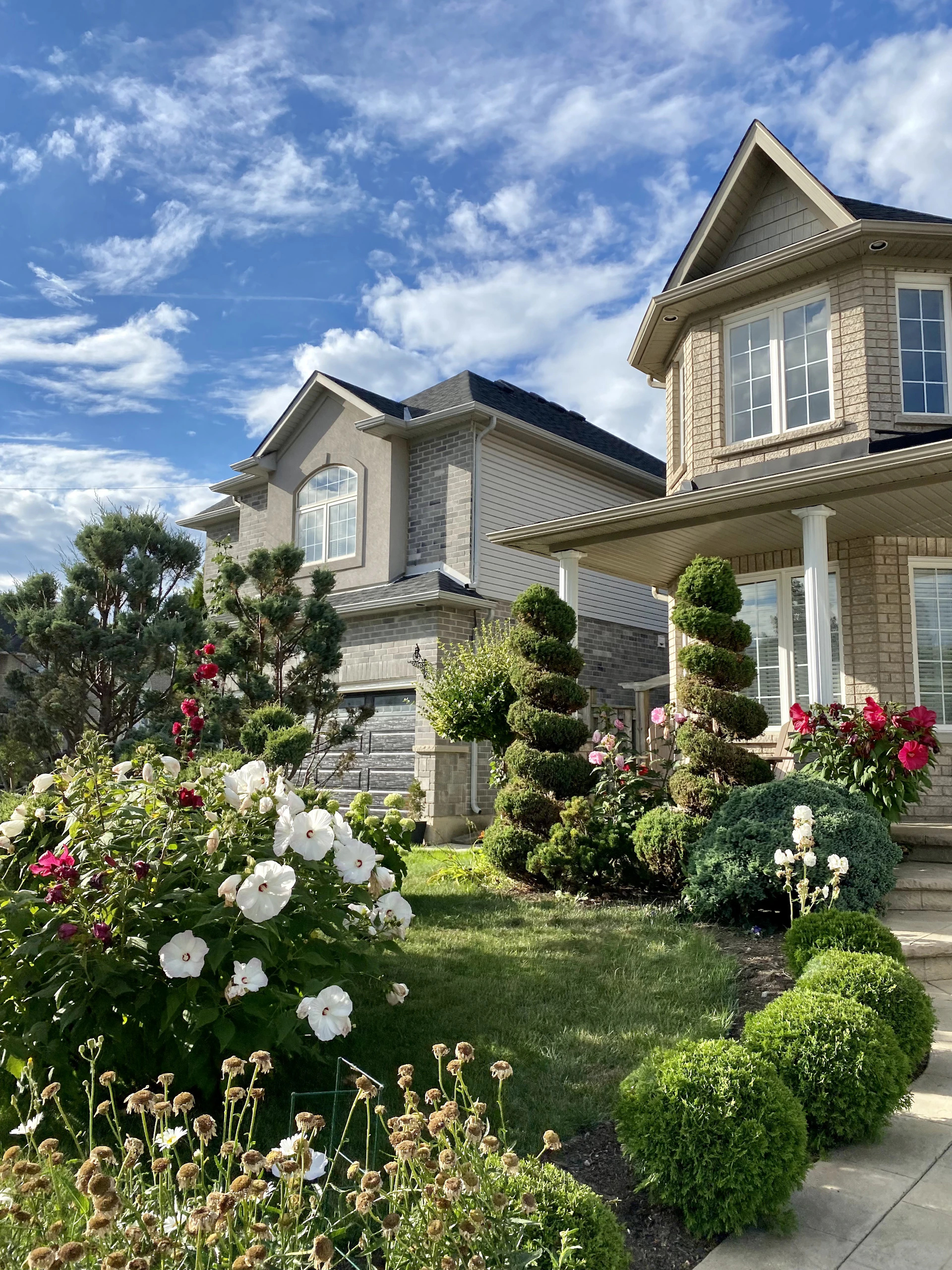 a house with a lot of flowers in front of it