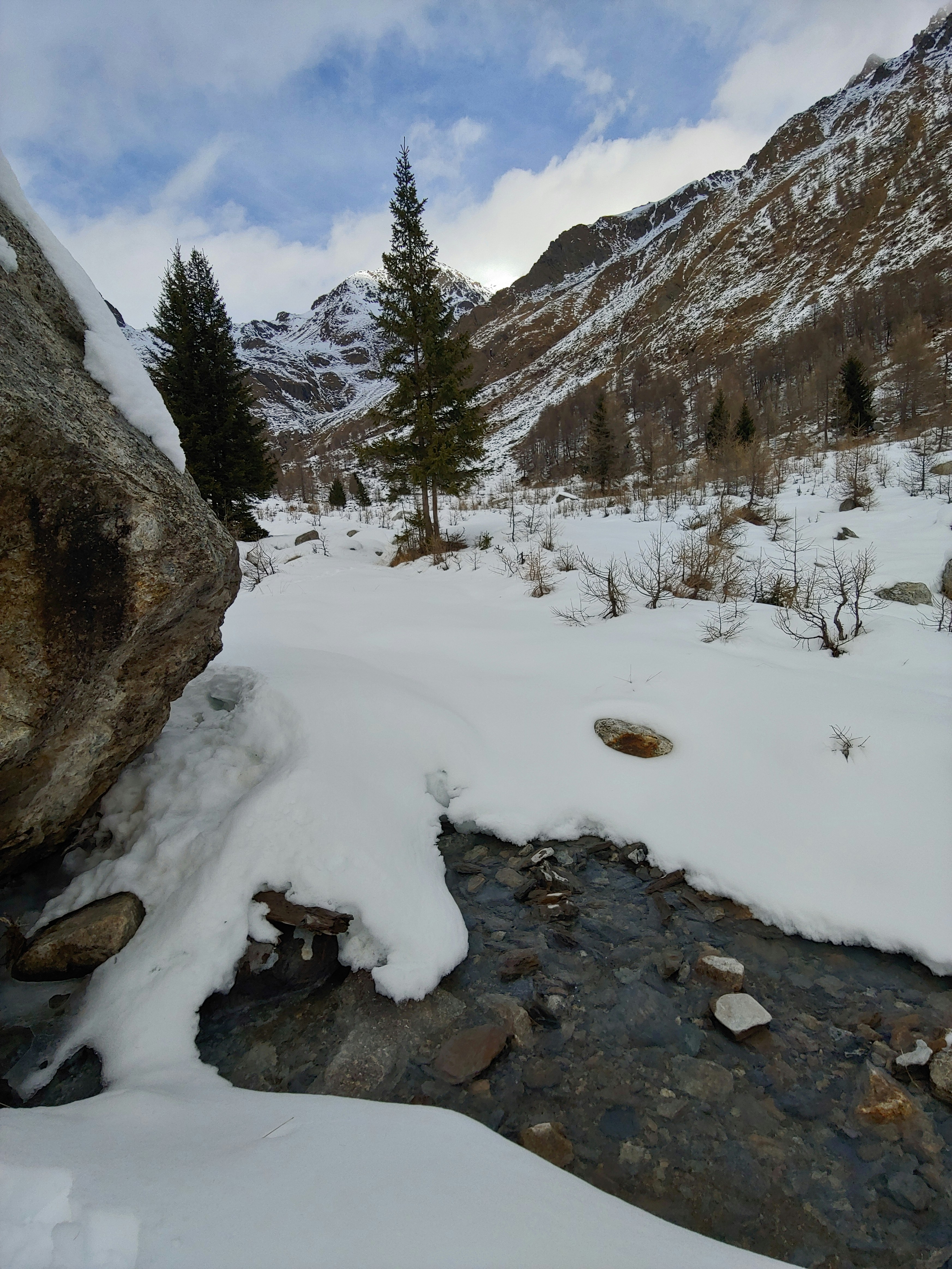 A stream running through a snow covered valley photo – Free Nature ...