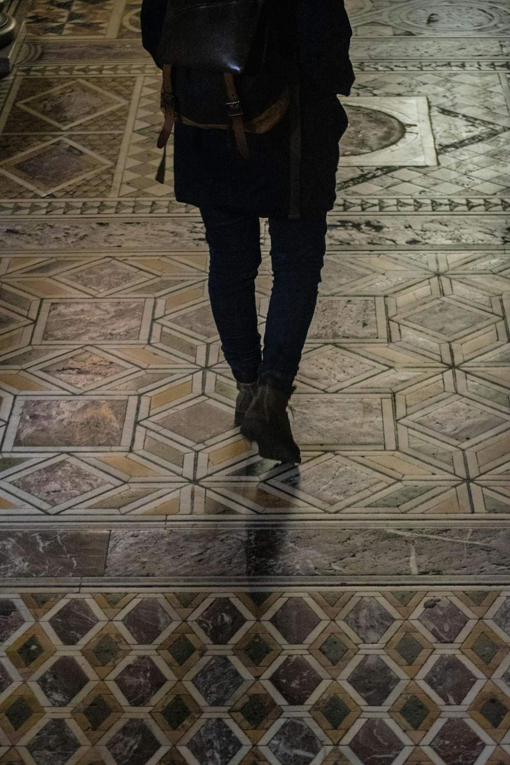 a person with a backpack walking down a hall