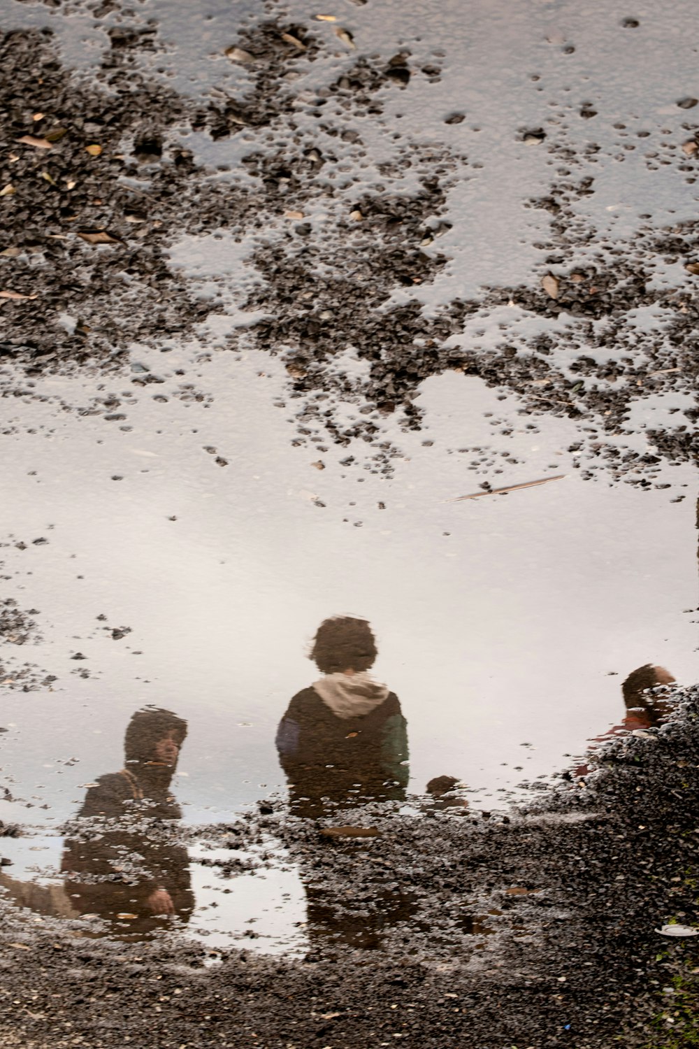 a group of people sitting in a puddle of water