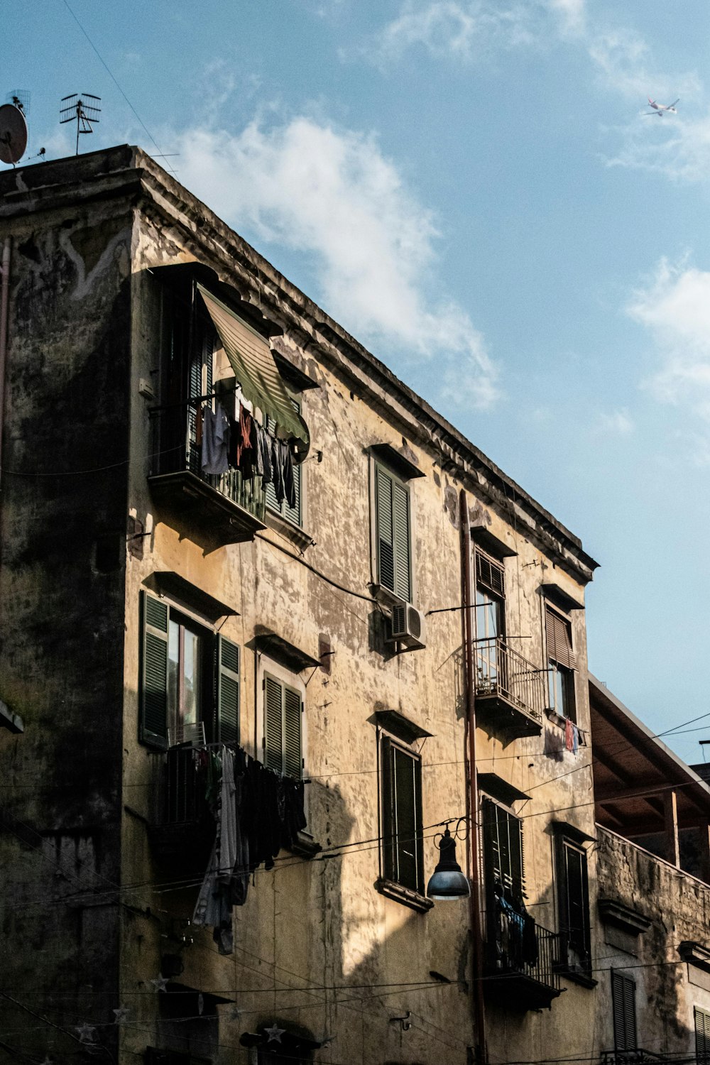 an old building with clothes hanging out of the balconies