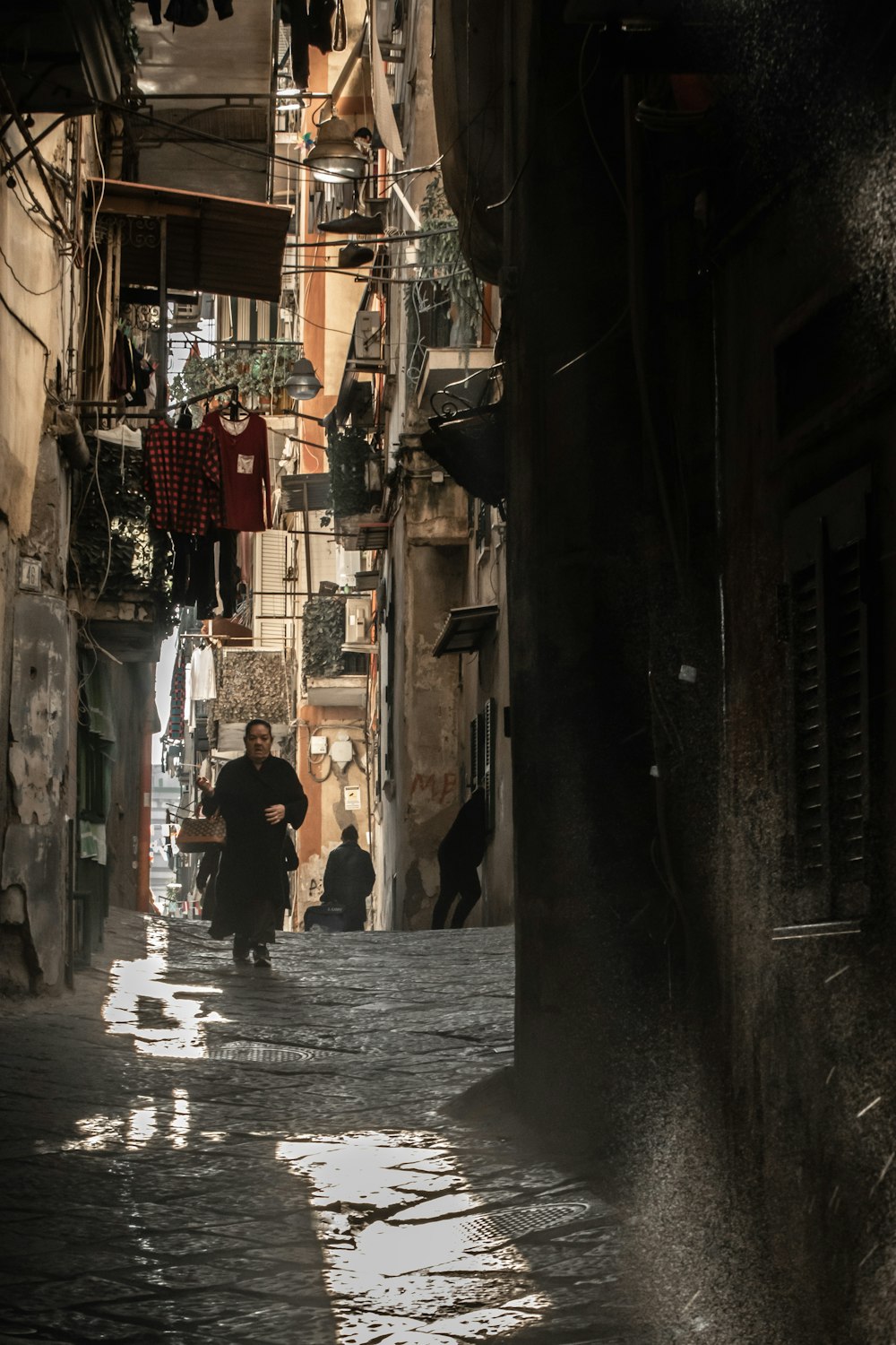 a person walking down a narrow alley way