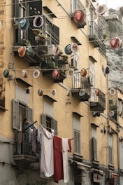 a building with a bunch of pots and pans hanging from it's windows
