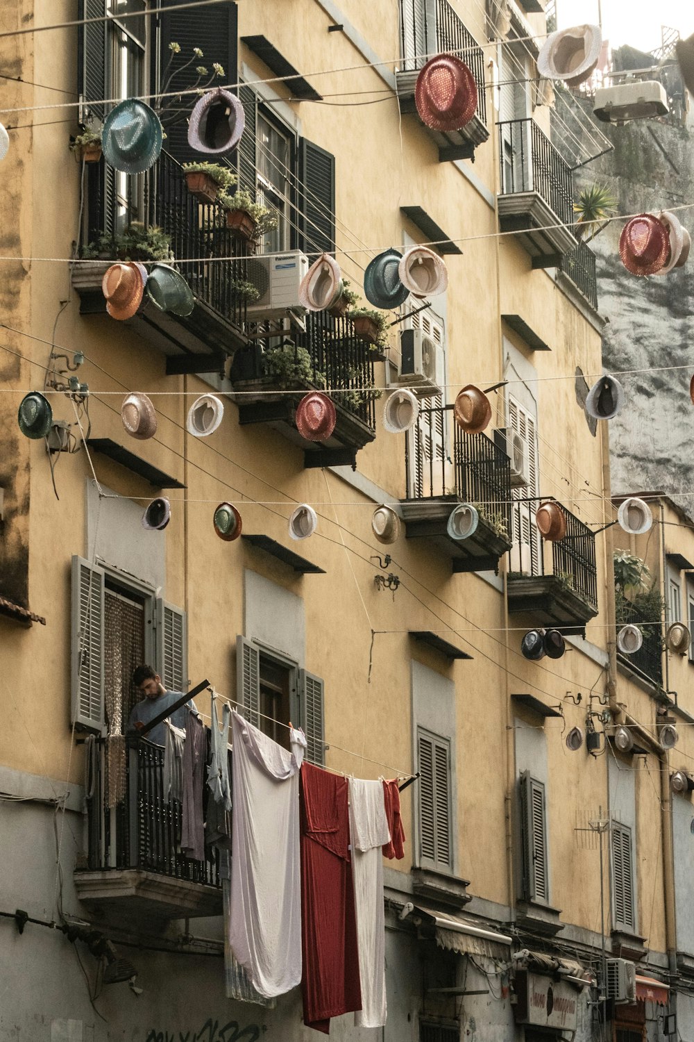 a building with a bunch of pots and pans hanging from it's windows