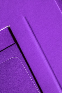 Abstract composition of overlapping fabric panels creating geometric shapes and shadows.