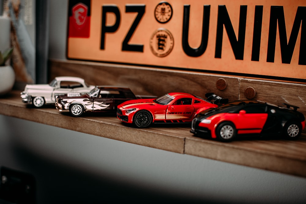 a group of toy cars sitting on top of a shelf