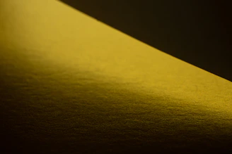 A minimalist UV-printed piece illuminated by subtle golden light, highlighting its delicate textures.