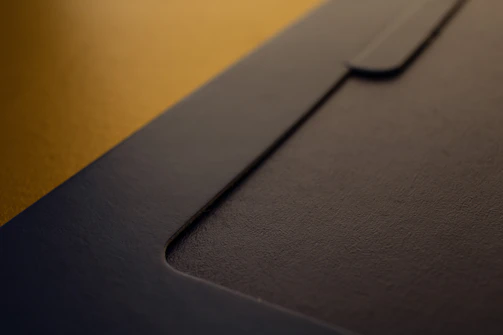 Close-up of a folder with custom branding and high-quality paper texture.
