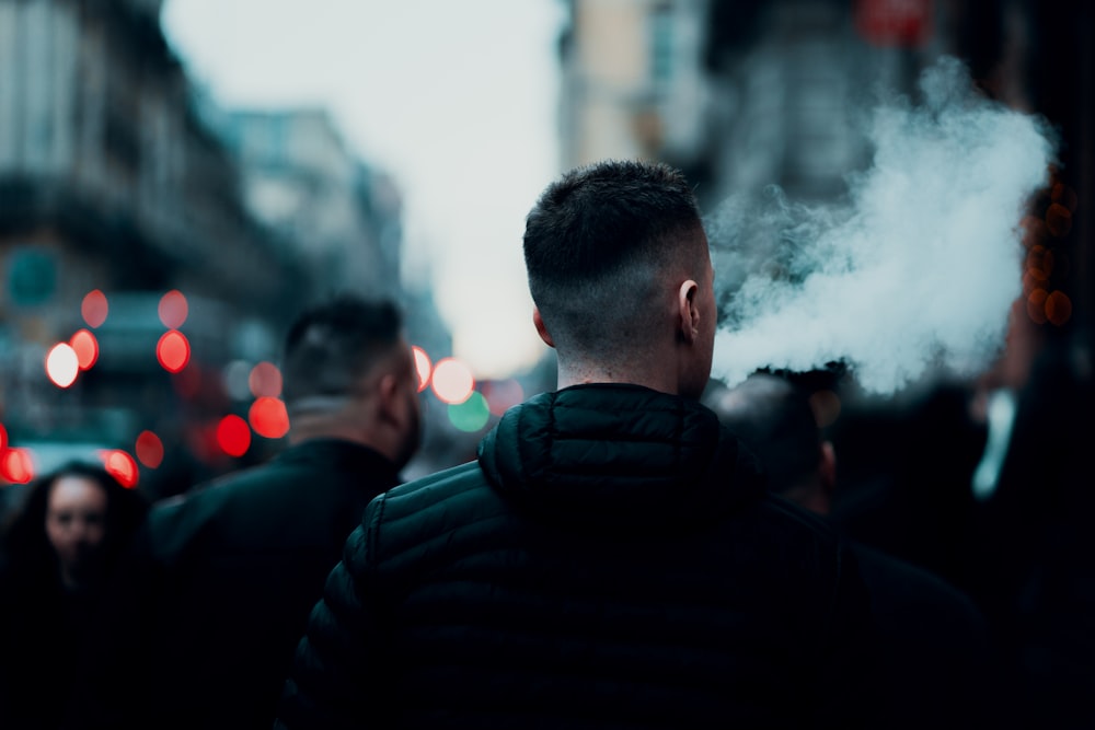 a man smoking a cigarette on a city street