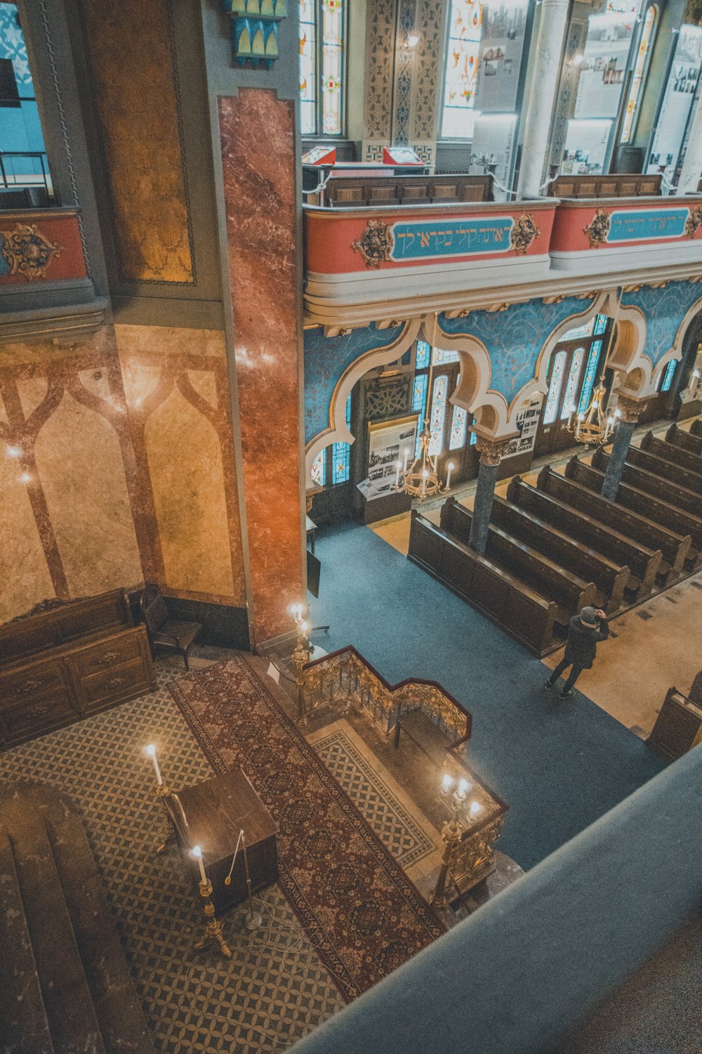 an aerial view of a church with pews and stained glass windows