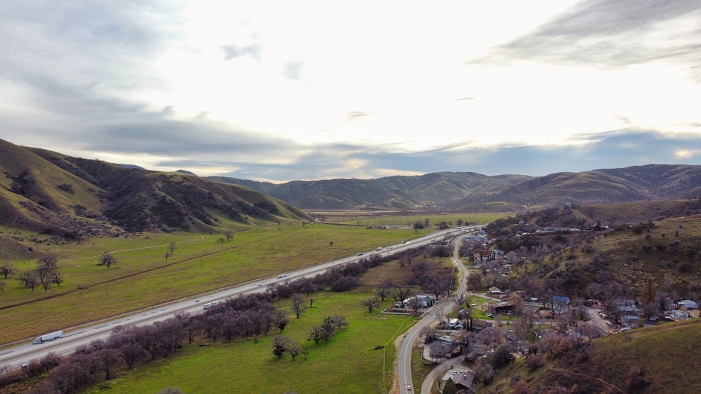 an aerial view of a rural area with mountains in the background