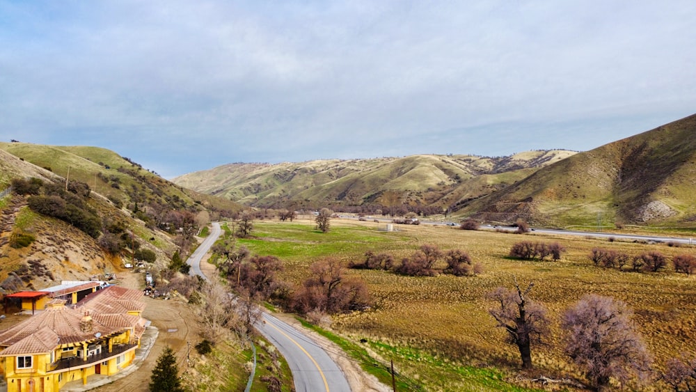 a scenic view of a rural area with mountains in the background