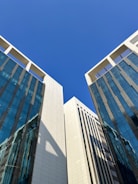a couple of tall buildings sitting next to each other